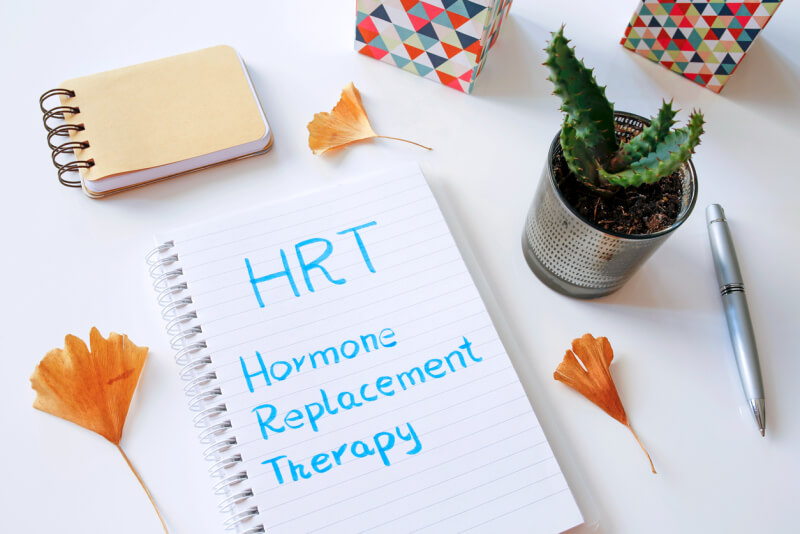 HRT Hormone Replacement Therapy written in notebook on white table